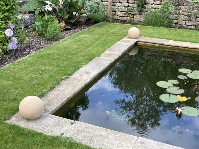 Cast stone ball 280mm around pond